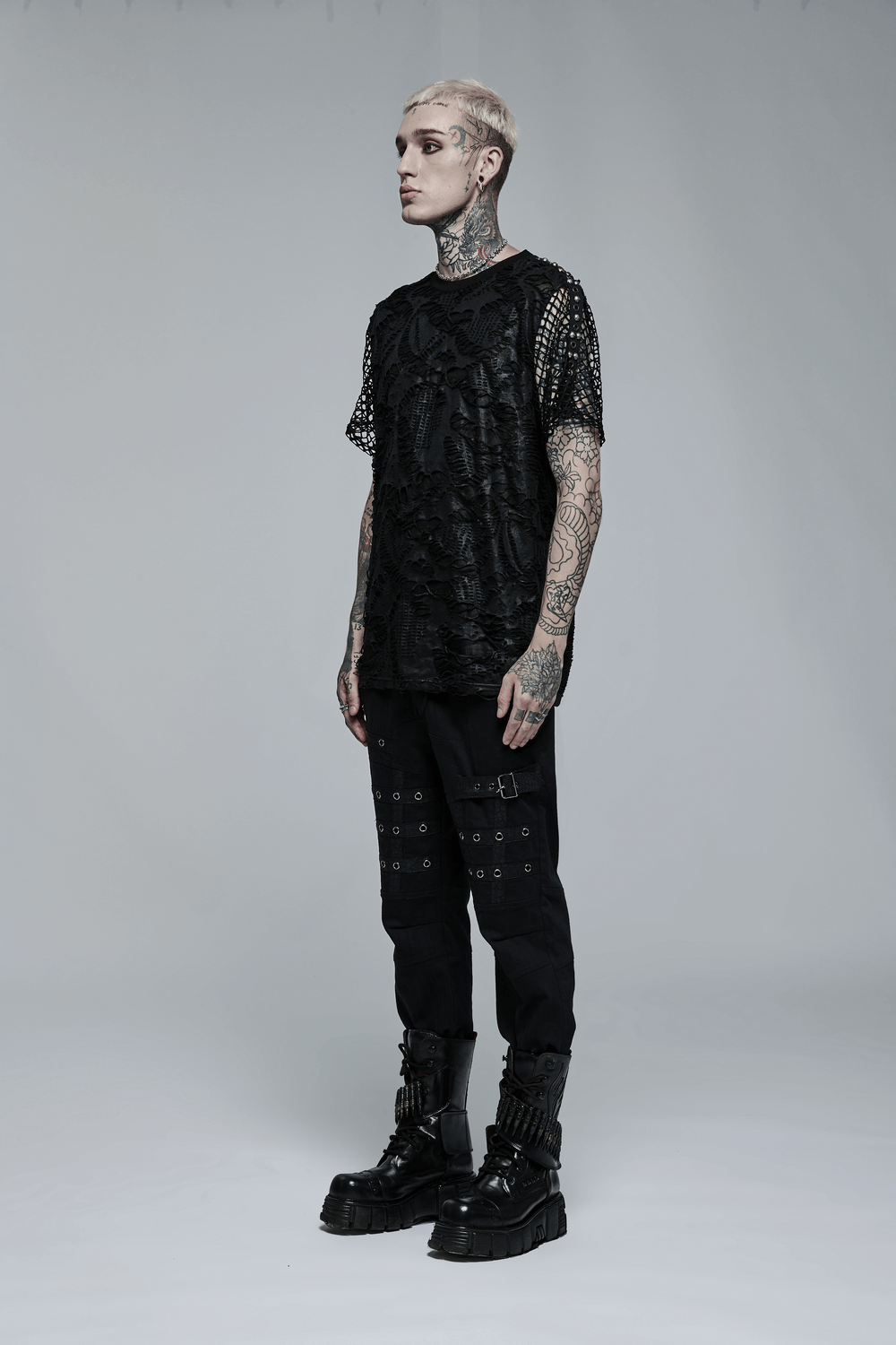 Edgy Gothic Mesh Layered Tee on model showcasing unique mesh overlay and textured arm adornments, perfect for a bold look.
