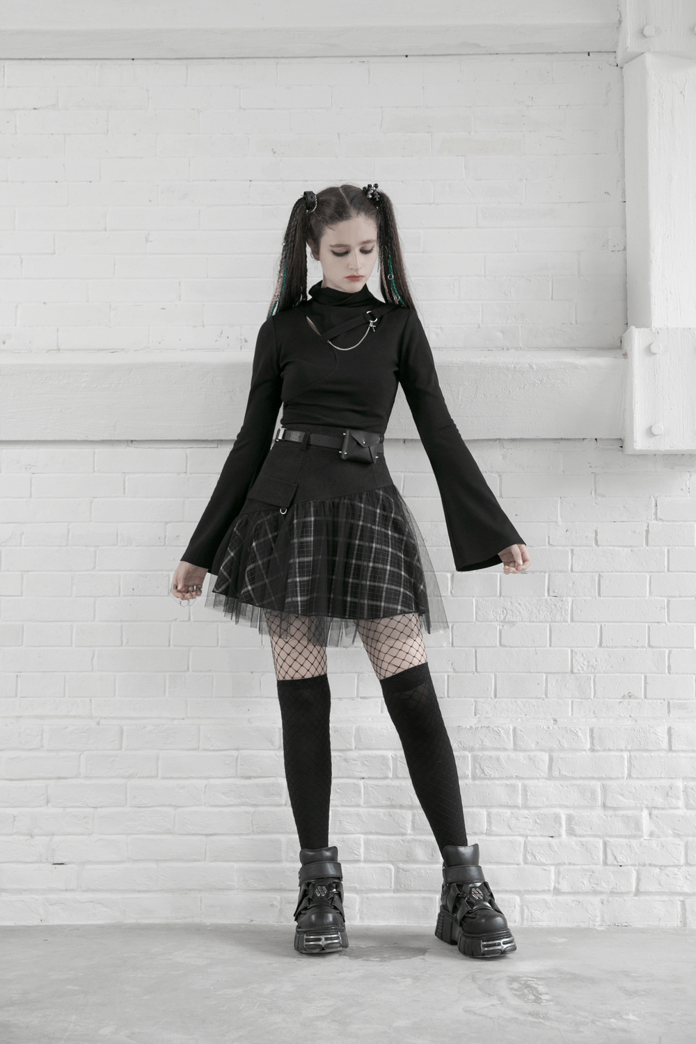 Punk high-waist plaid and tulle mini skirt with stylish black top and chunky boots, showcasing edgy street fashion.