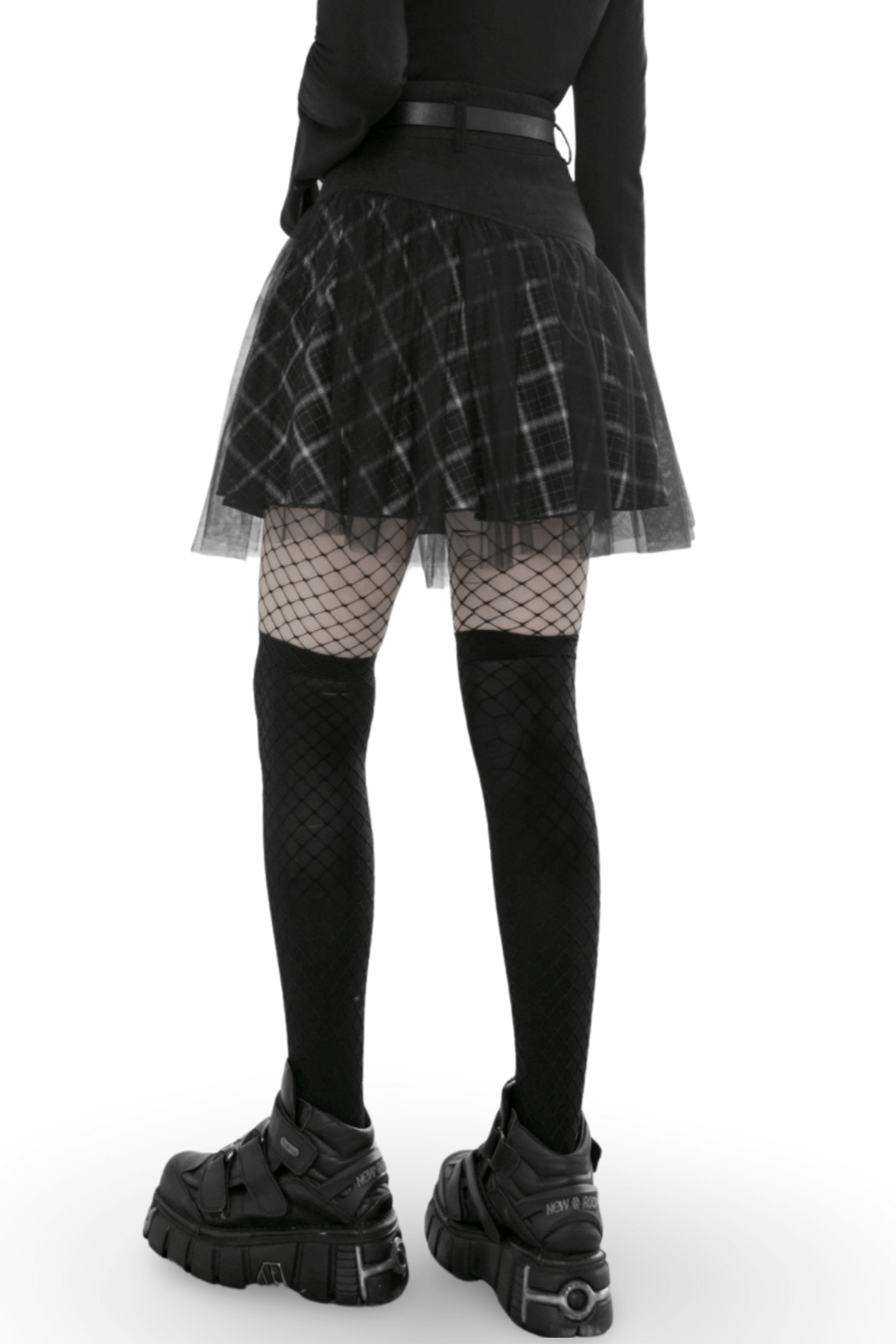 Back view of edgy high-waist plaid and tulle punk mini skirt with fishnet tights and chunky sneakers.