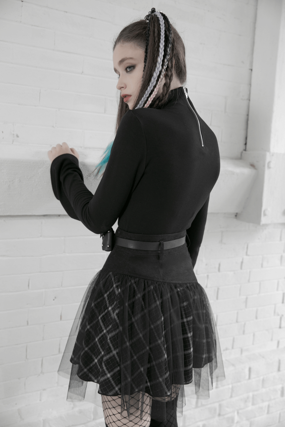 Model showcasing an edgy high-waist plaid and tulle punk mini skirt, highlighting its unique layered design.