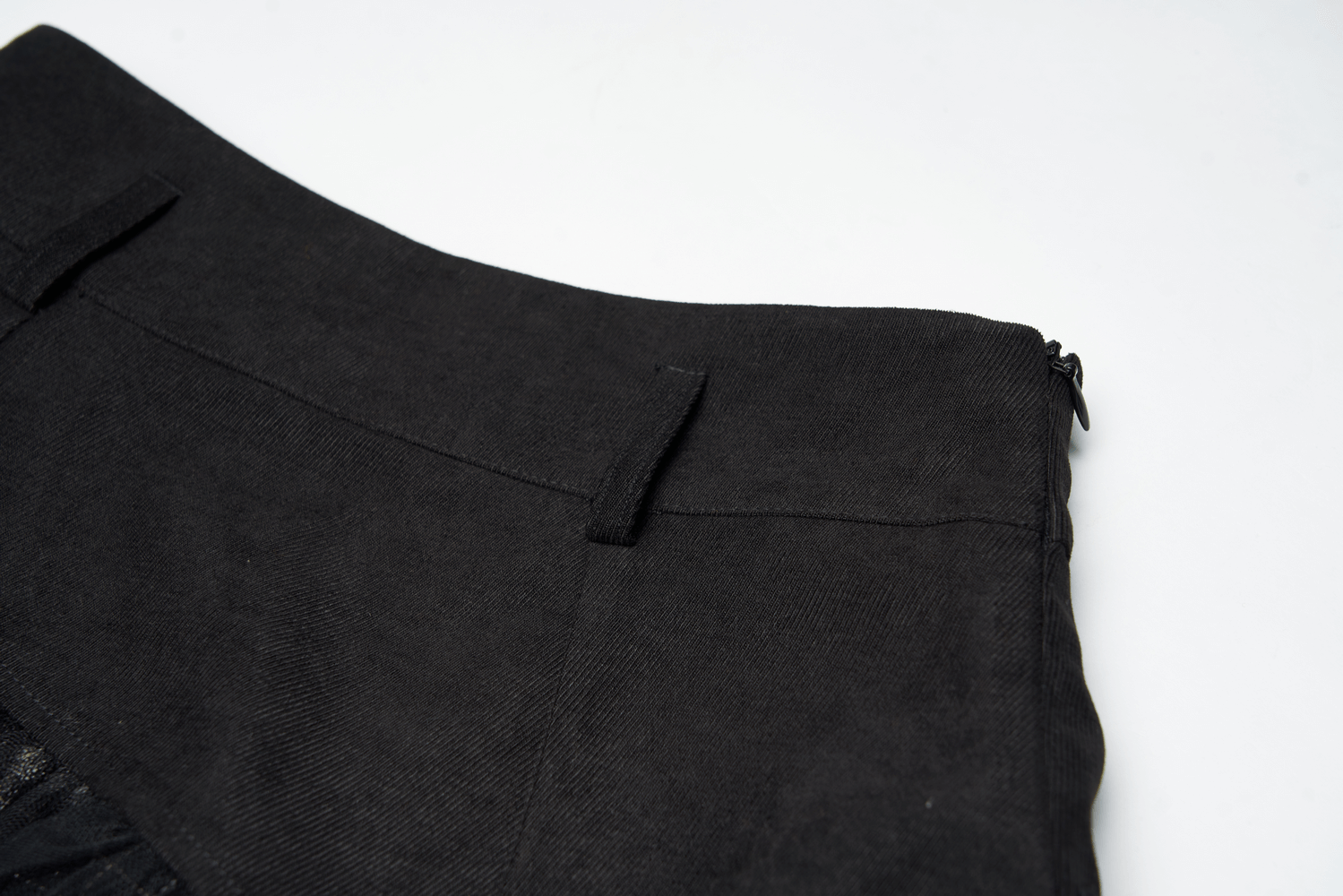 Close-up of the edgy high-waist plaid and tulle punk mini skirt showcasing the textured black fabric and zipper detail.