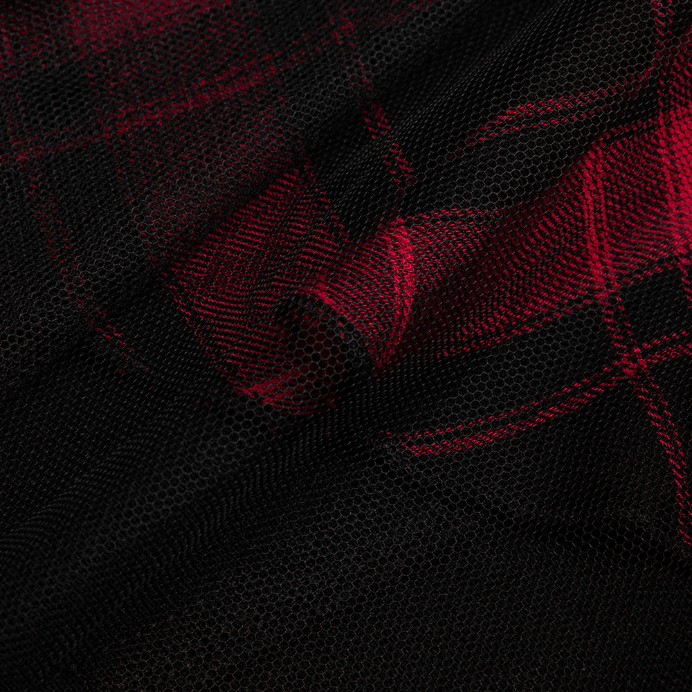 Close-up of edgy black and red plaid mesh fabric, showcasing the unique texture for a punk-inspired look.