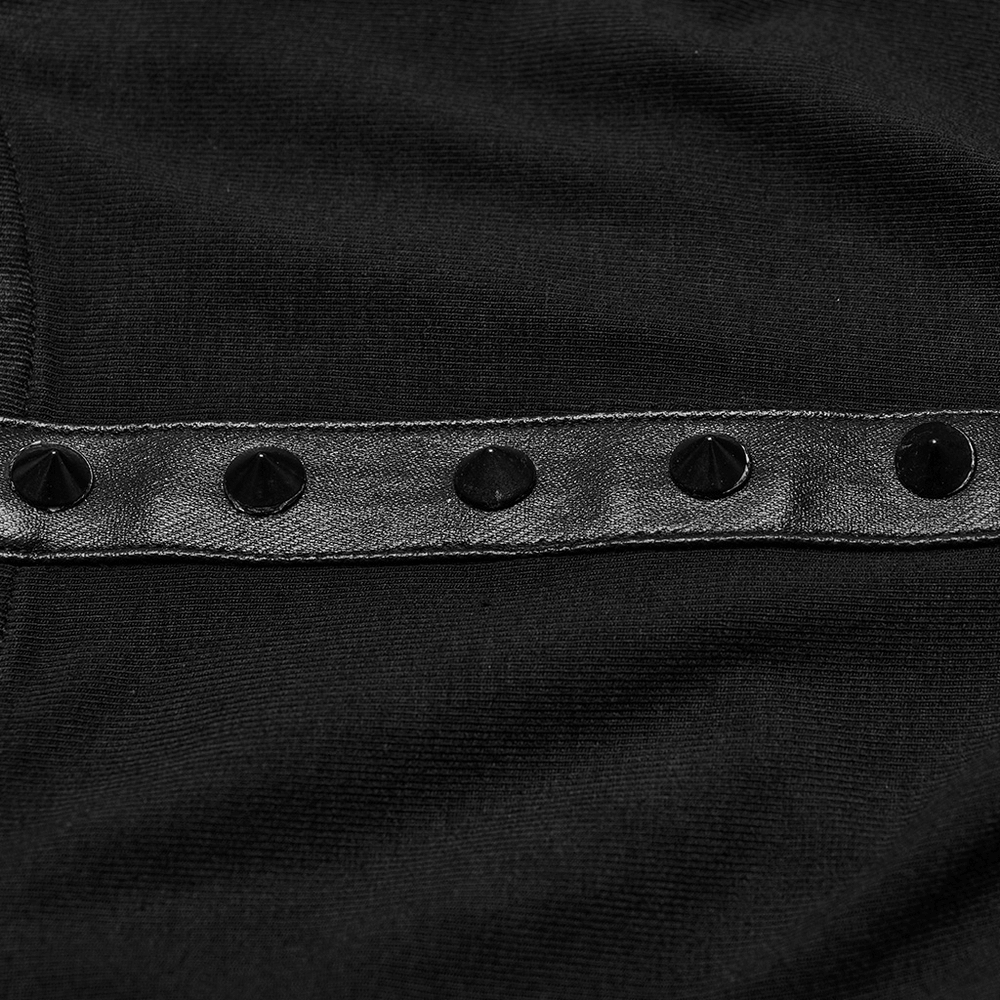 Close-up of decorative black studs on a stylish black fabric, enhancing edgy cropped hooded top design.