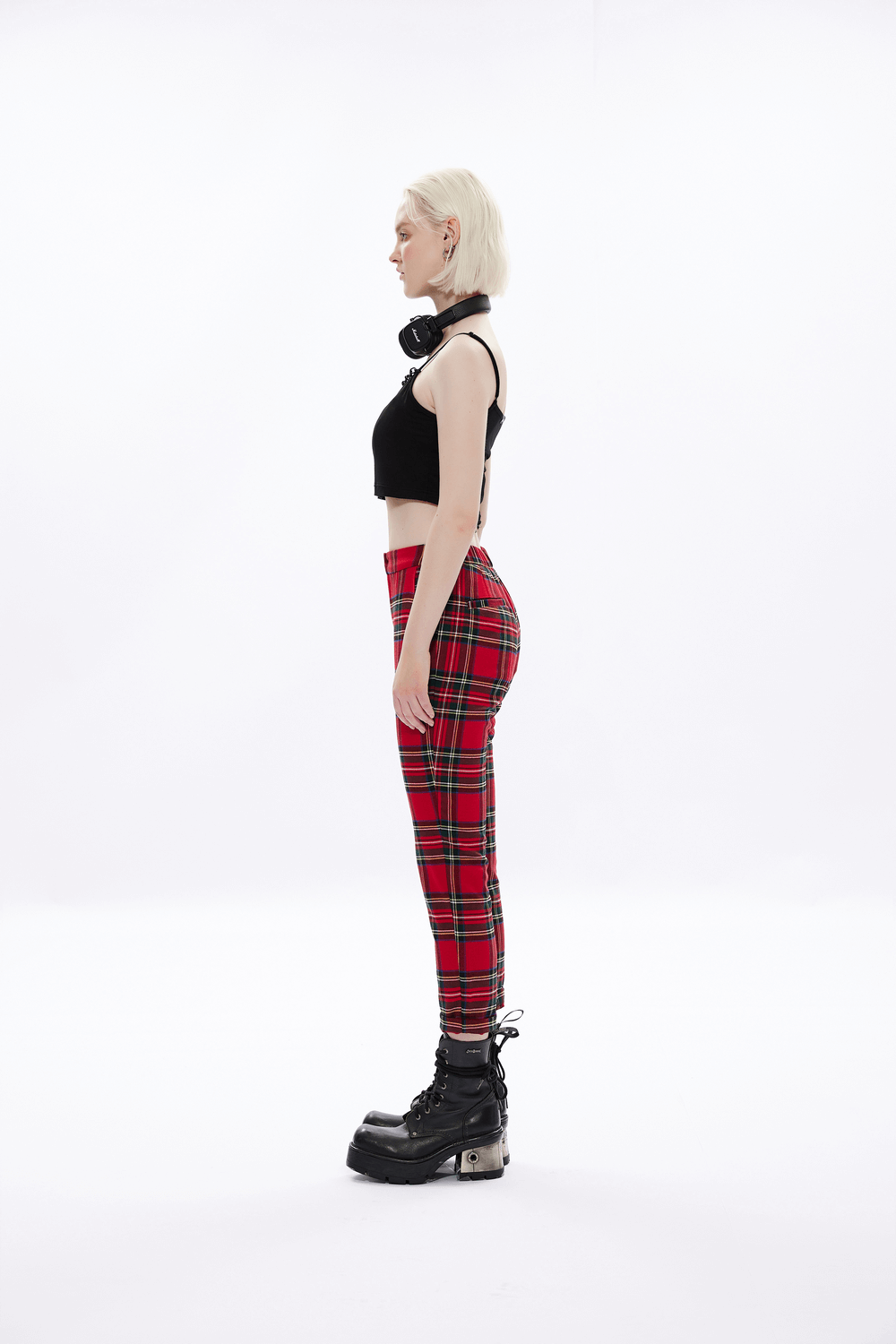 Model showcasing edgy knit camisole with detachable punk chain and plaid pants, perfect for a rebellious look.