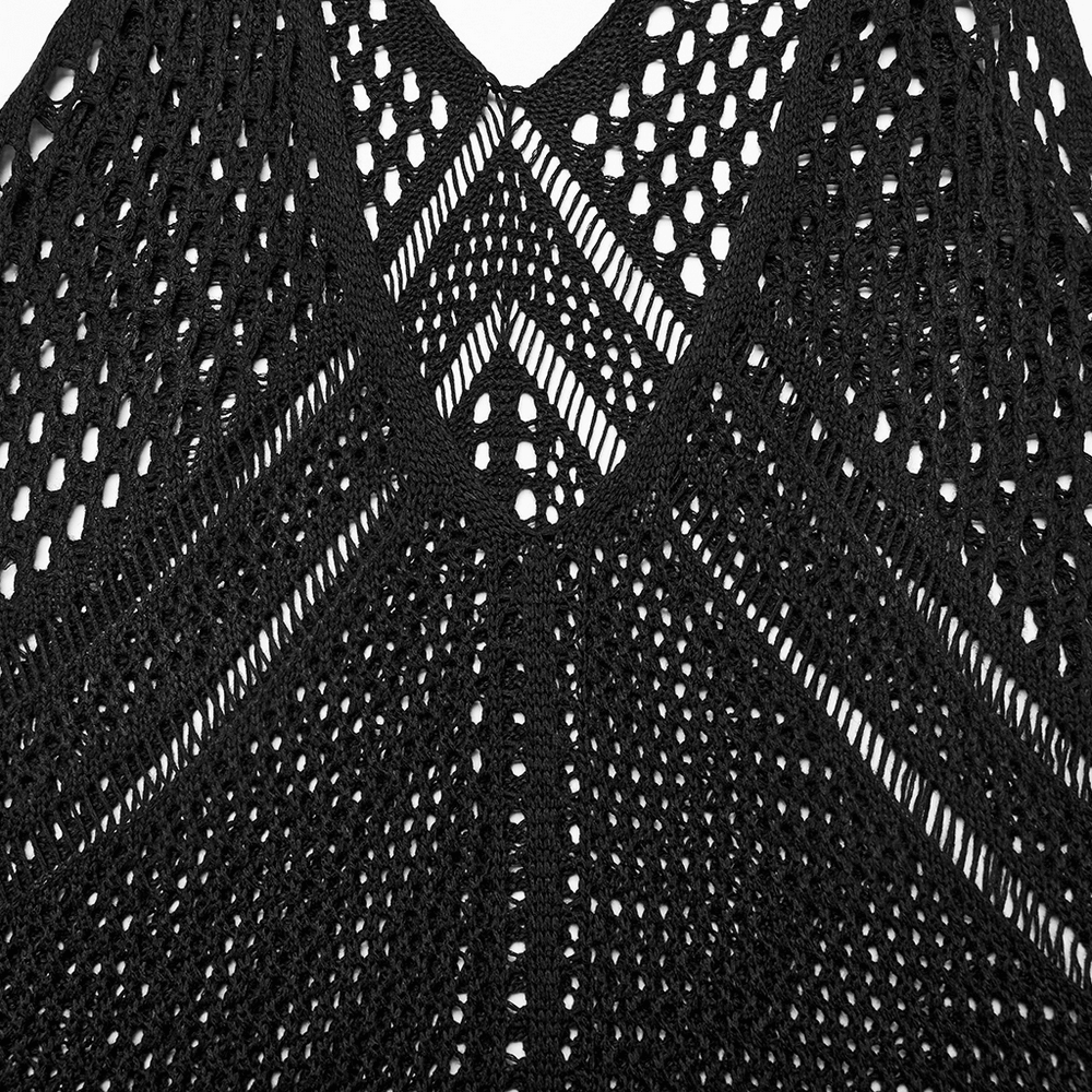 Close-up of the edgy knit techwear V-neck detail featuring bold patterns and textures in black fabric.