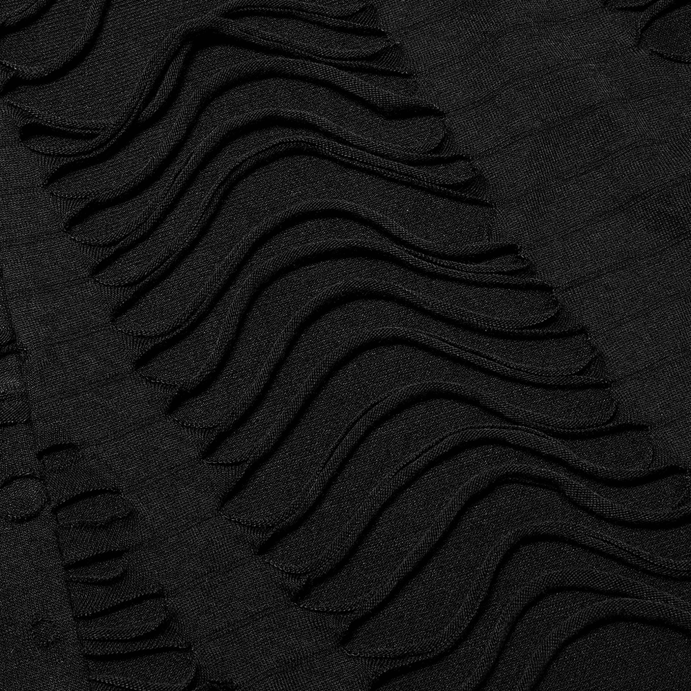 Close-up of textured black knit fabric featuring waves and loops for an edgy goth style.