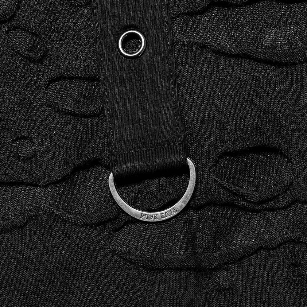 Close-up of black knitted fabric with destructed holes and a stylish silver loop detail.