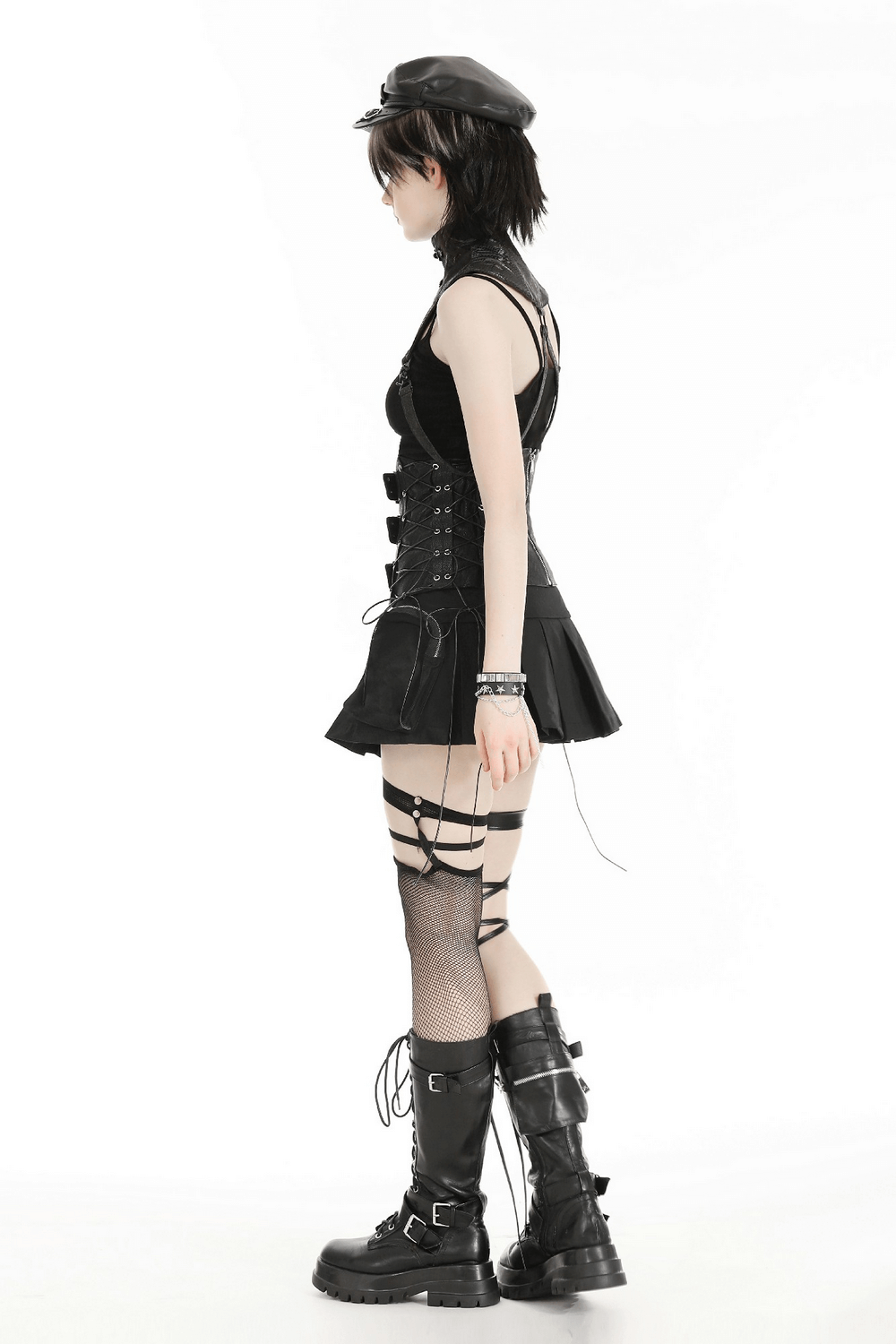Edgy fashion model showcasing a black leather lace-up corset dress and knee-high combat boots