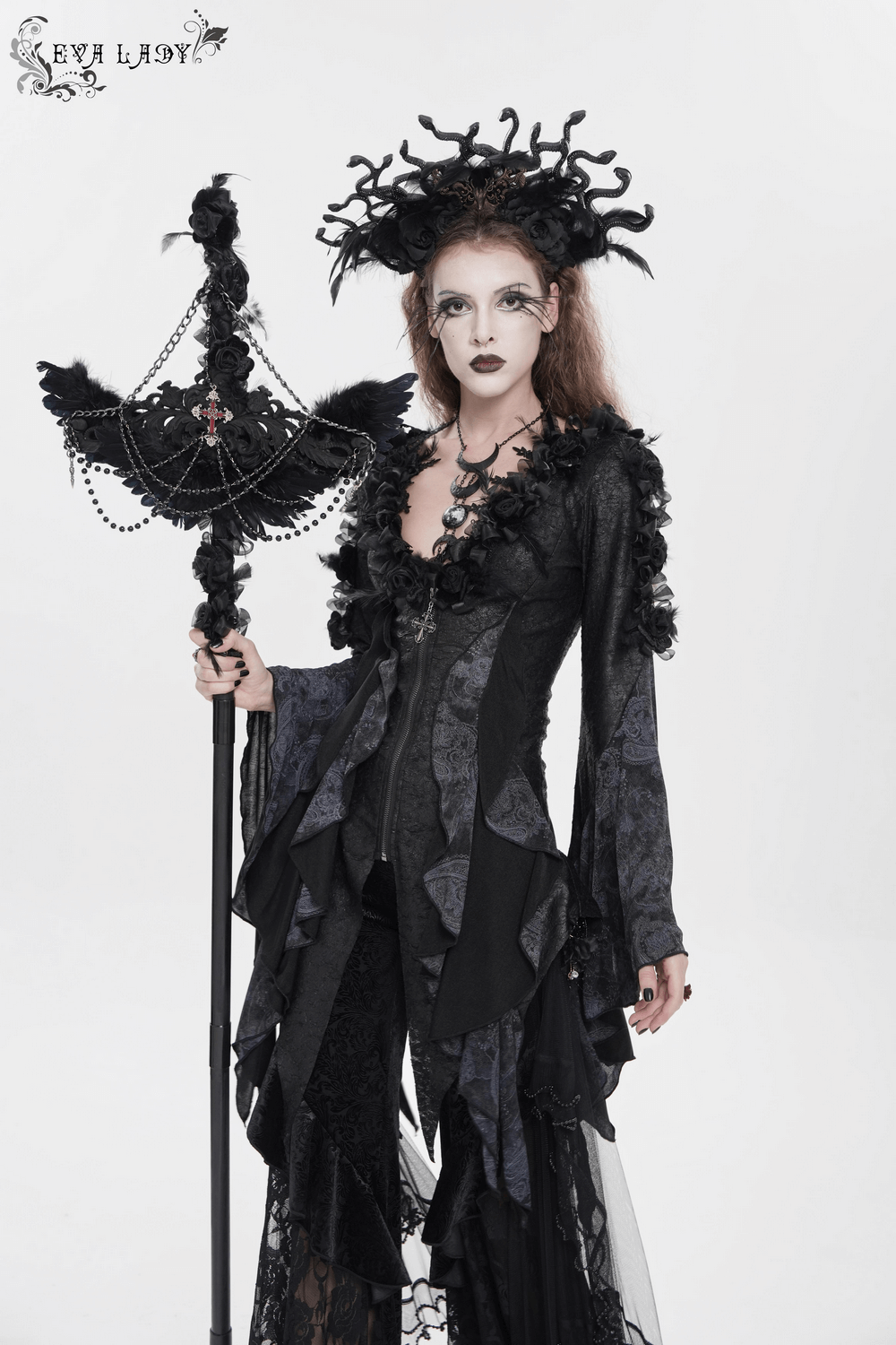 Edgy Lace-Up Blouse with Rose Trim and Bell Sleeves modeling gothic fashion with dramatic accessories.