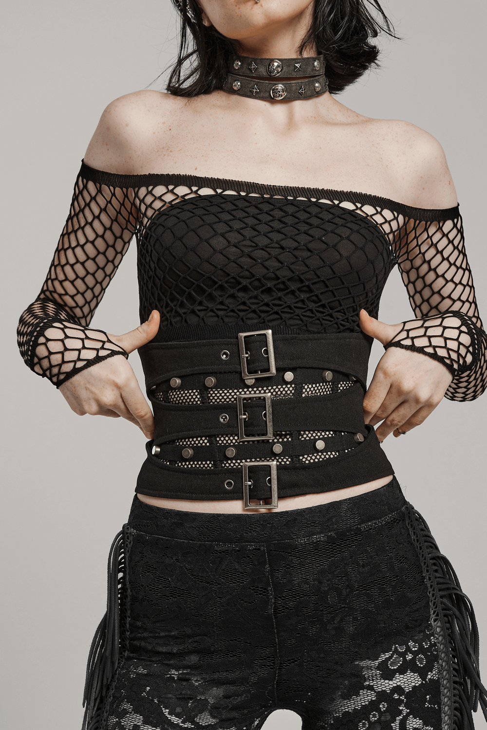 Edgy off-shoulder punk outfit featuring a lace-up corset belt with mesh and buckle details, perfect for bold fashion statements.