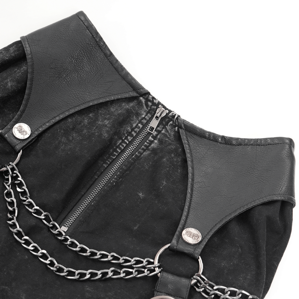 Close-up of black gothic skirt featuring leather accents and chains, showcasing edgy zipper design.