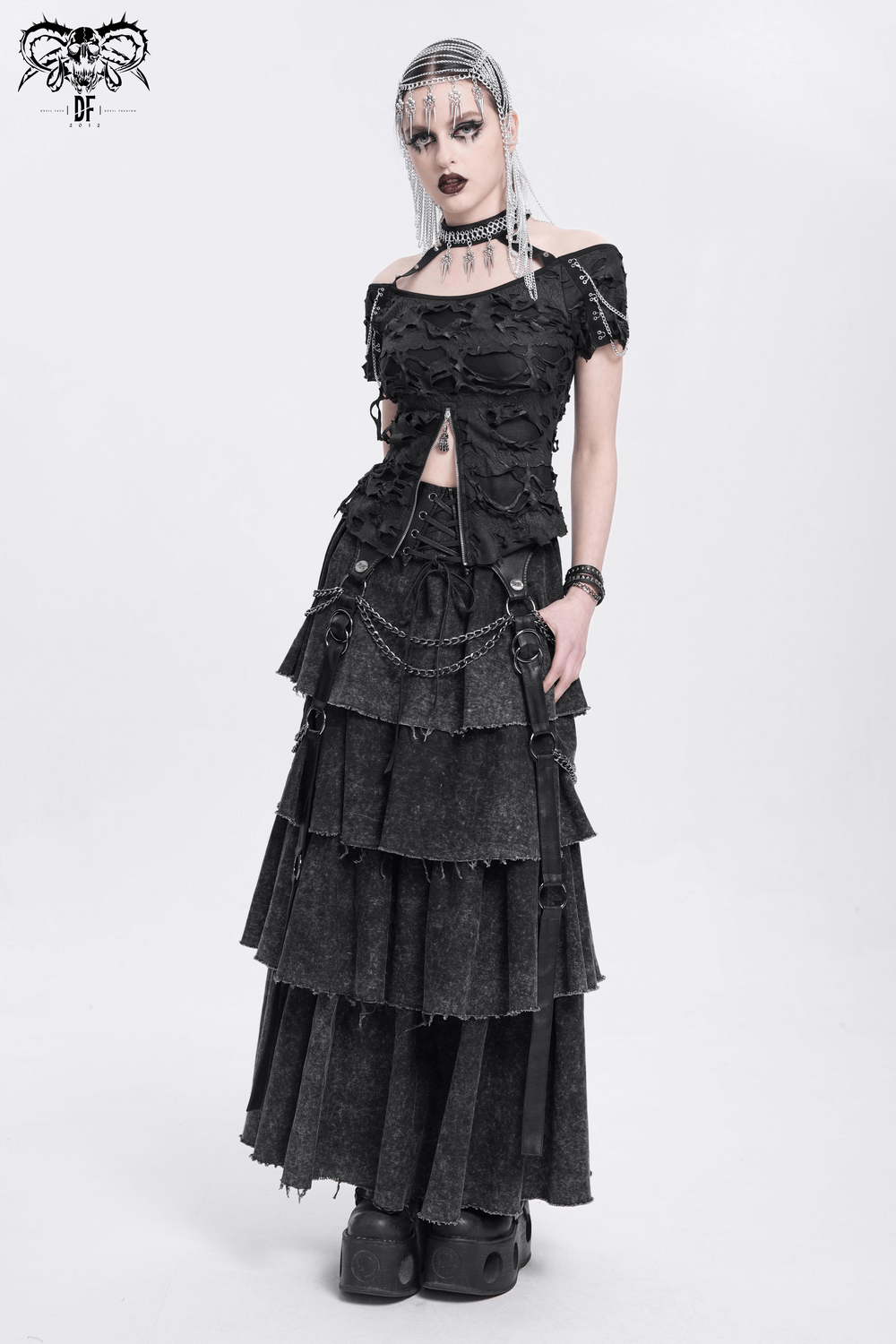 Edgy layered gothic skirt with chains and lace-up detail, styled for a bold, dark fashion statement.