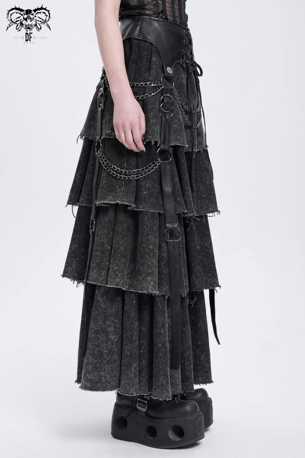 Edgy gothic skirt with chains and lace-up detail, showcasing layered black fabric and a unique silhouette.