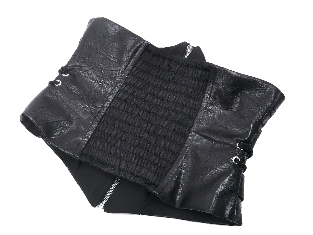 Edgy black leather corset belt with zipper, buckle details, and smocked panel for a stylish punk-inspired look.