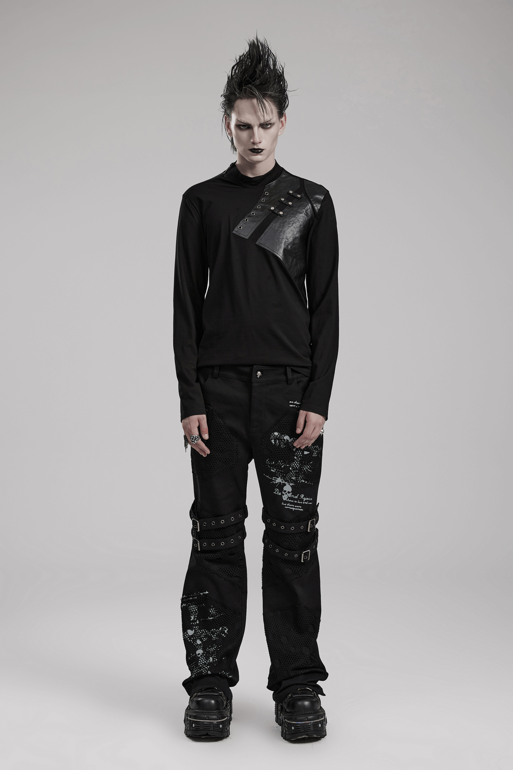 Edgy male model wearing a black long sleeve sweatshirt with metal accents, exuding punk style and attitude.