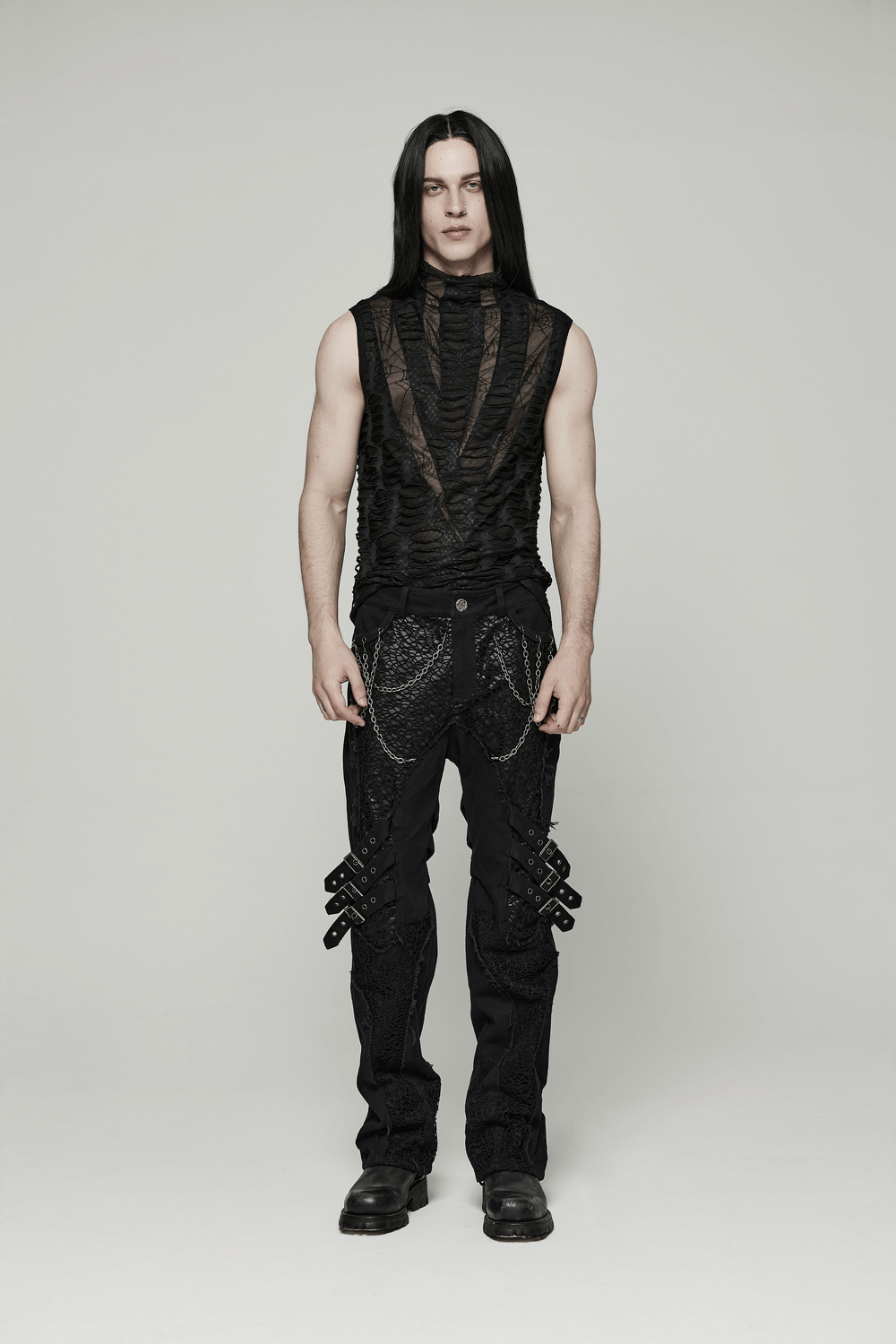 Edgy men's gothic sleeveless mesh top with sharp teeth design, paired with stylish black trousers.