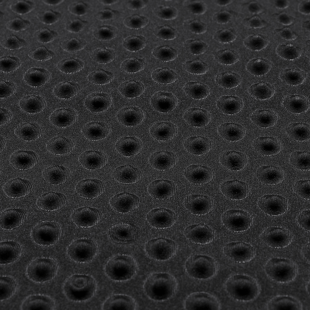 Close-up of edgy black mesh fabric with circular perforations for punk-style clothing.