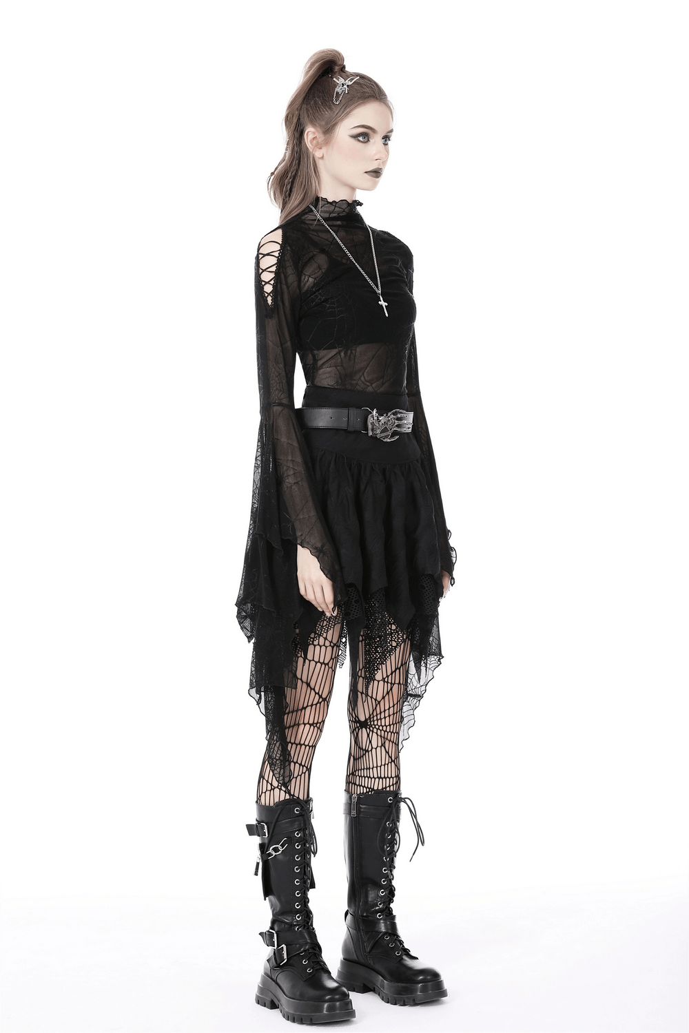 Edgy model wearing a black mesh skirt with lace trim, layered over fishnet tights, showcasing gothic style.