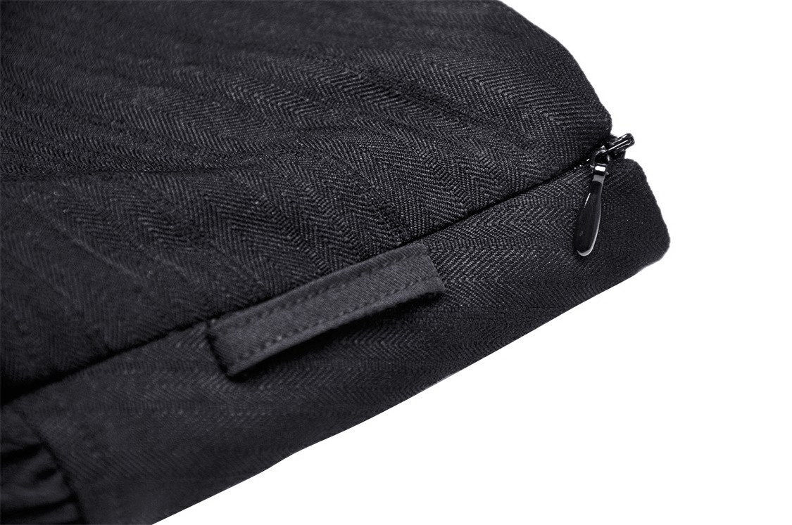 Close-up of a sleek black herringbone textured fabric with a zipper, showcasing a modern and stylish design.
