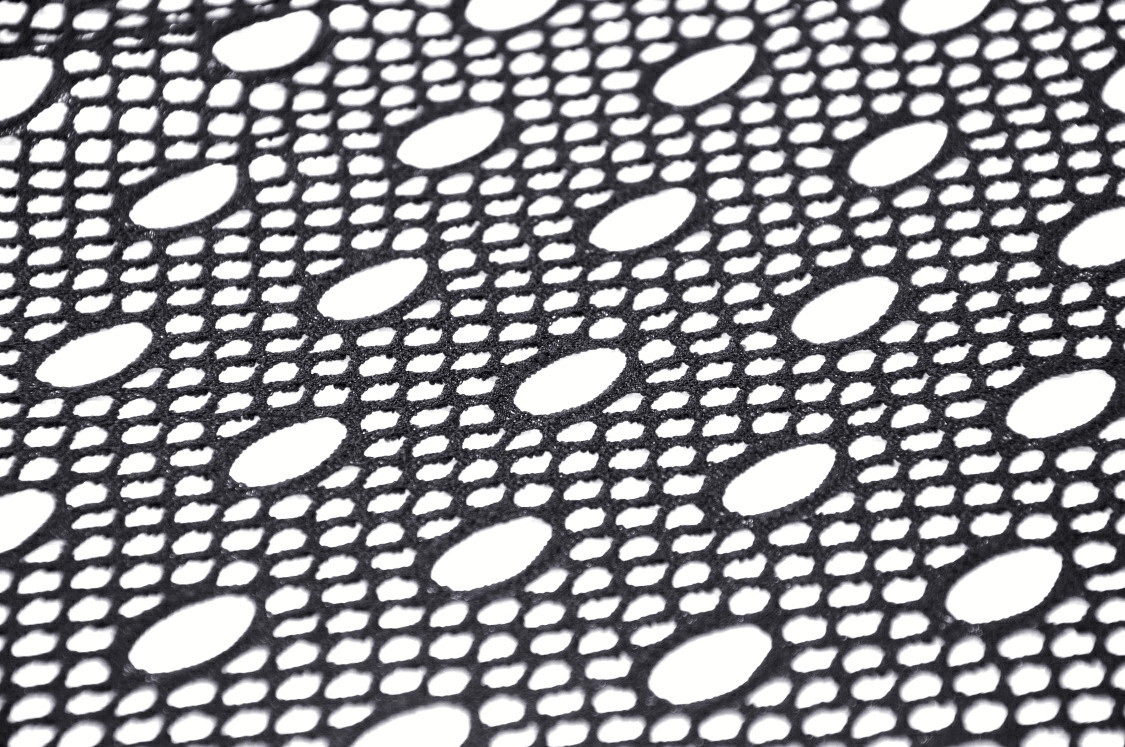 Black mesh fabric close-up featuring a unique pattern of holes and loops, perfect for edgy fashion designs.