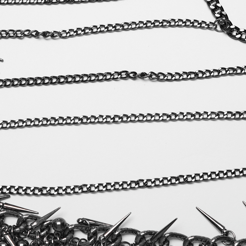 Close-up of an edgy metal chain harness featuring rivet detailing and alloy chains.