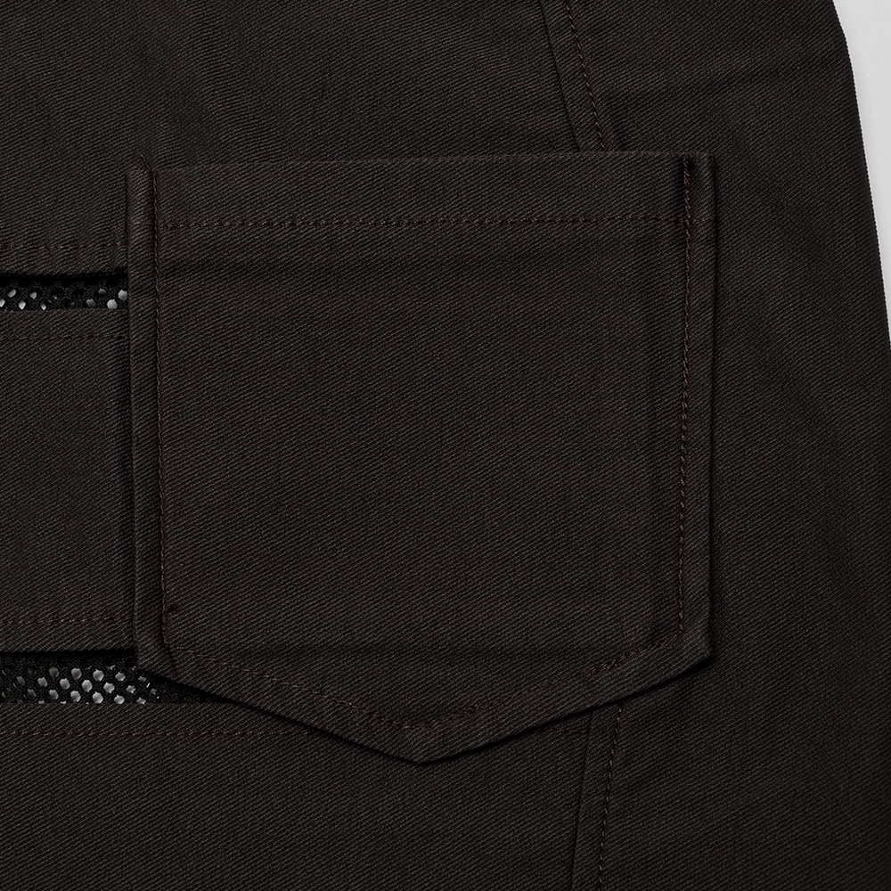 Close-up of a black denim pocket with diamond mesh detail, showcasing punk rock style and edgy fashion.