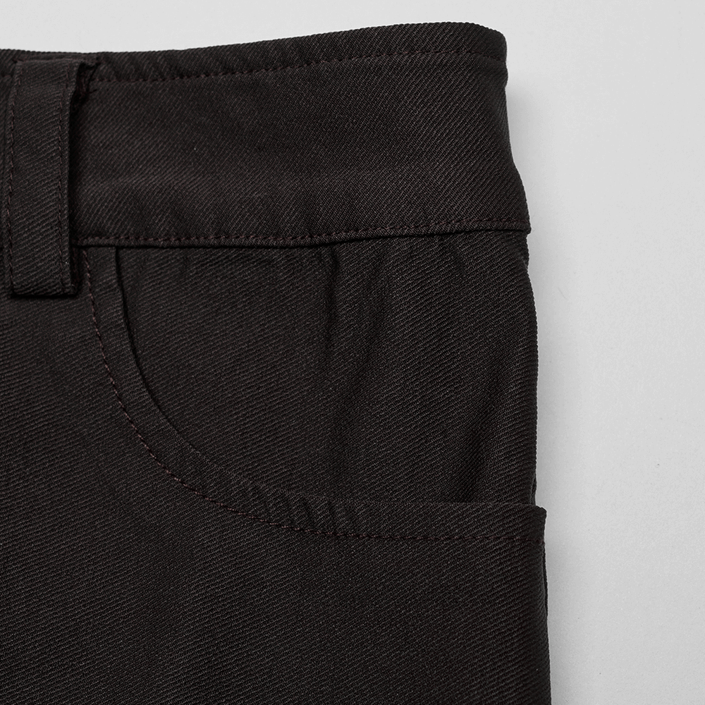 Close-up of the waistband and pocket of an edgy mini denim skirt.