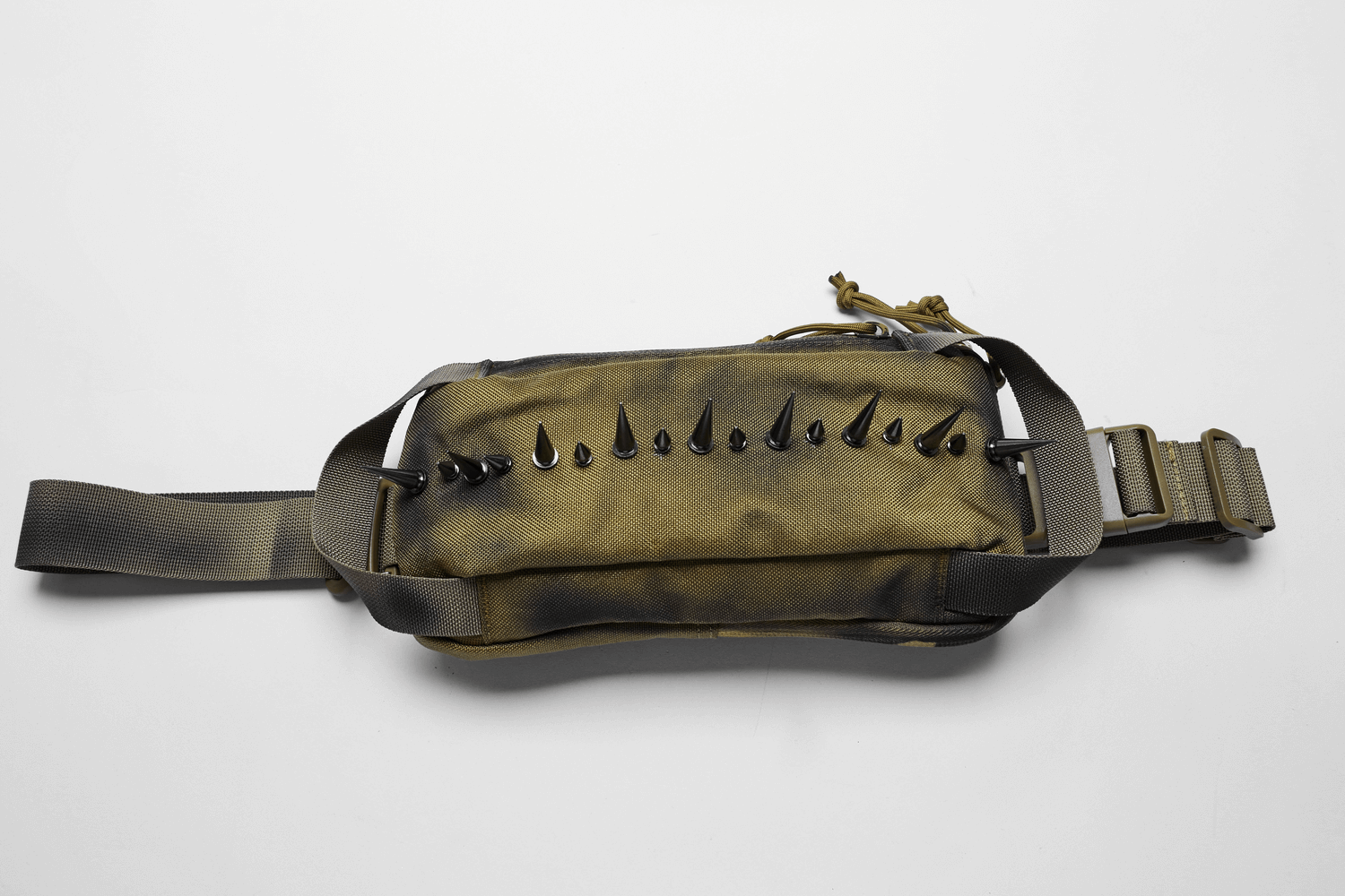 Edgy one-strap spiked nylon shoulder bag in olive green, perfect for urban streetwear styles.