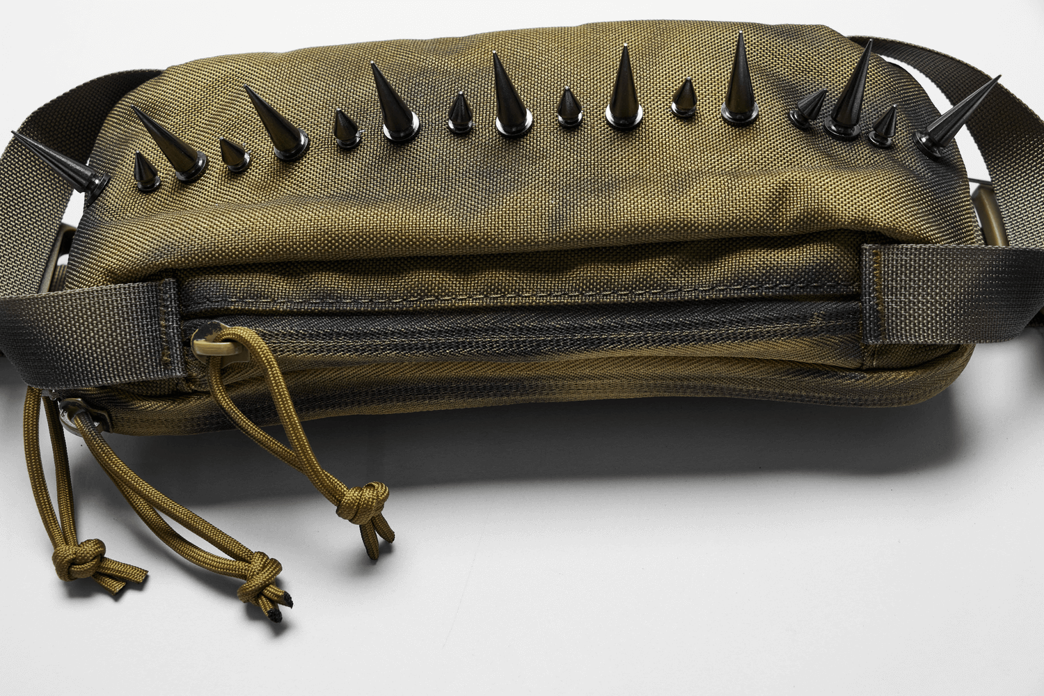 Edgy nylon spiked shoulder bag with black spikes, ideal for streetwear and alternative fashion looks.
