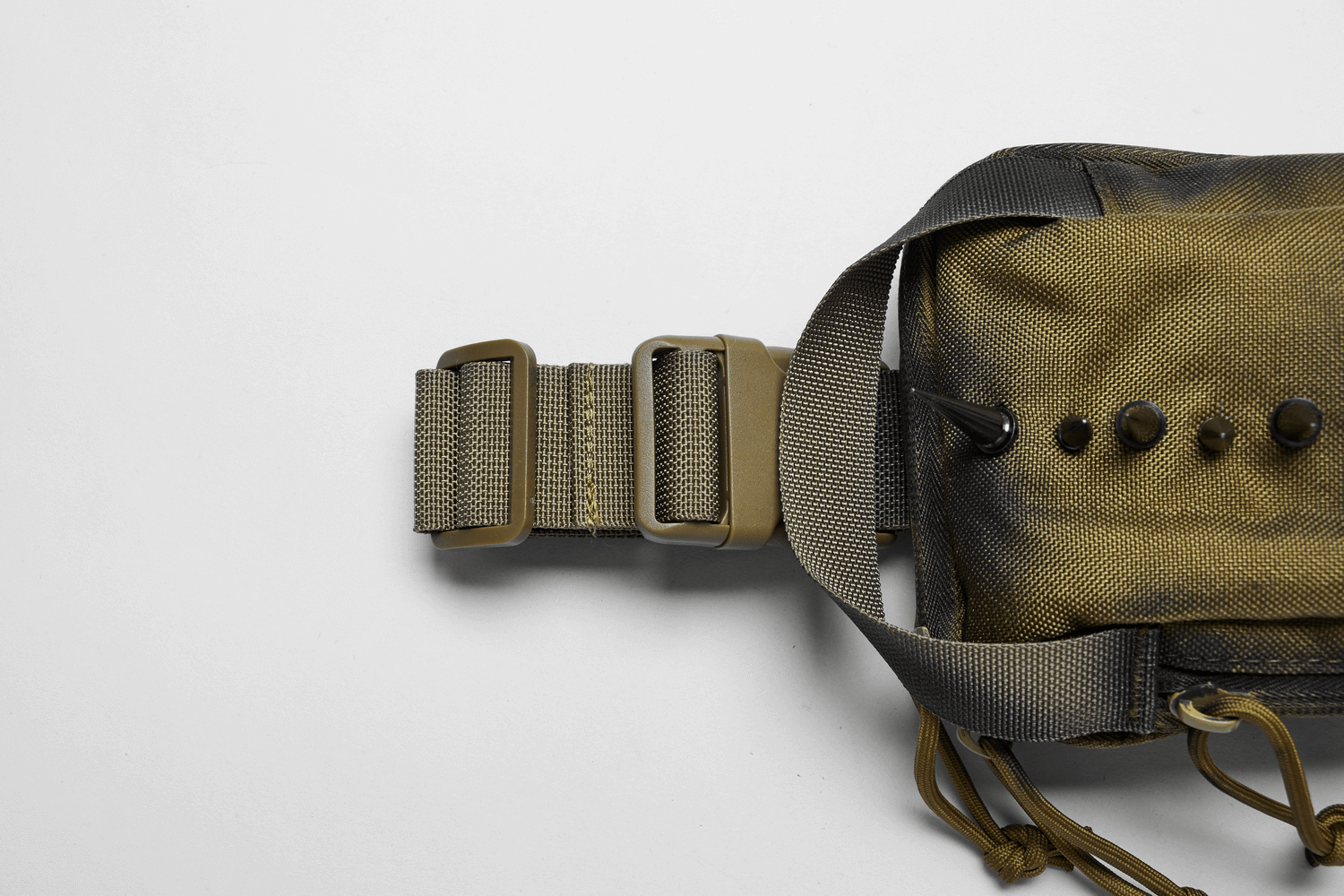 Detail of Edgy Nylon Spiked Shoulder Bag's unique strap and spikes showcasing alternative fashion appeal.