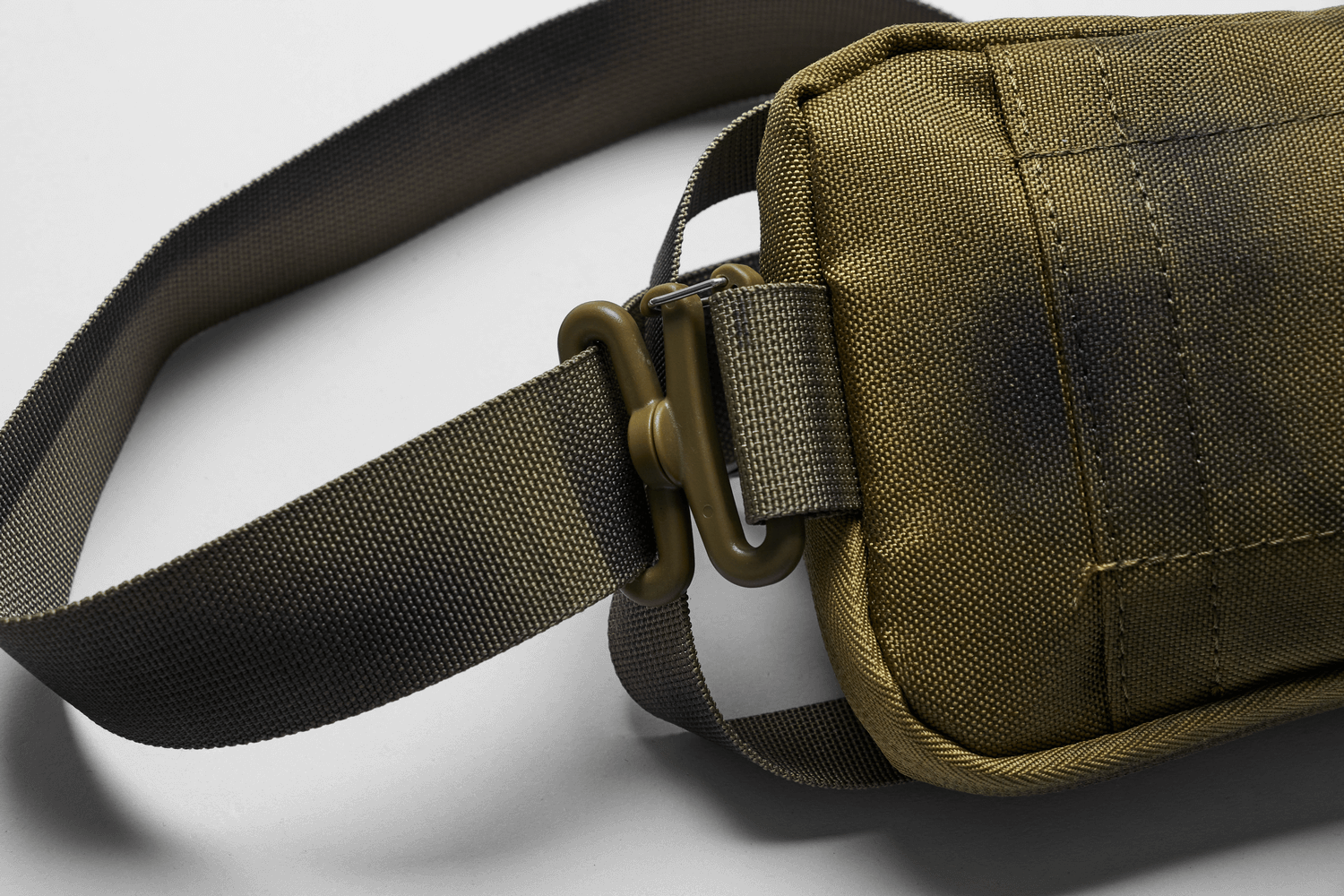 Close-up of the edgy nylon spiked shoulder bag showcasing its durable material and adjustable strap detail.