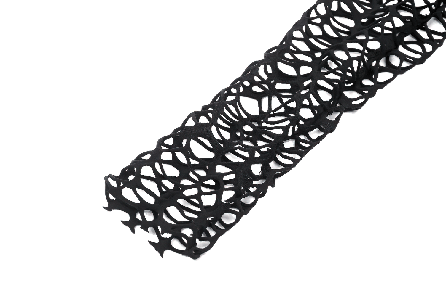 Close-up of black open-knit mesh fabric with spiderweb design from edgy gothic top.