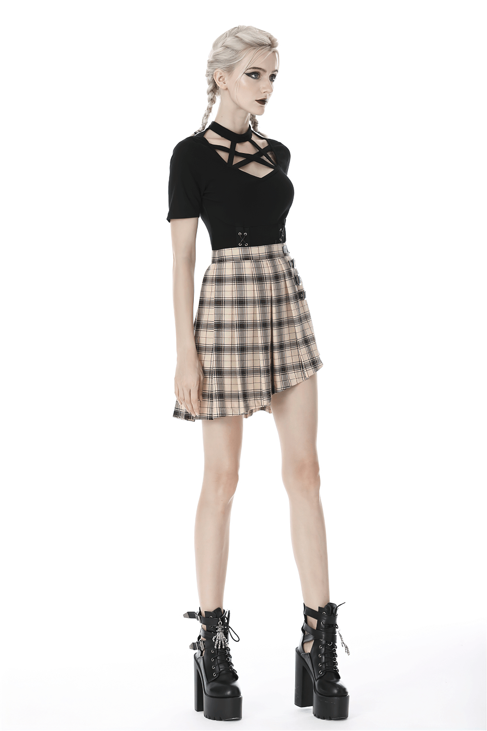 Edgy plaid asymmetrical skirt with bold buckles paired with a stylish black top and platform boots.
