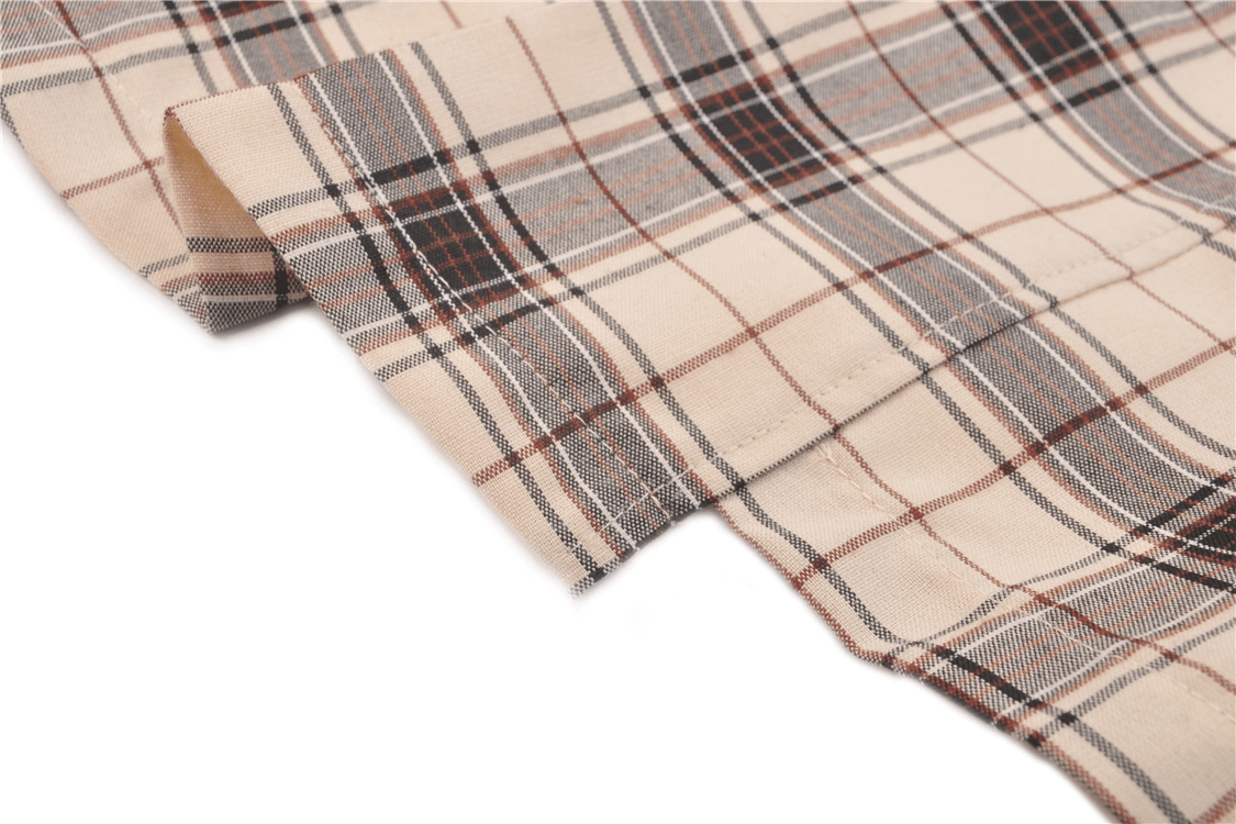 Close-up of stylish plaid fabric featuring a checkered pattern, perfect for an edgy asymmetrical skirt with bold buckles.