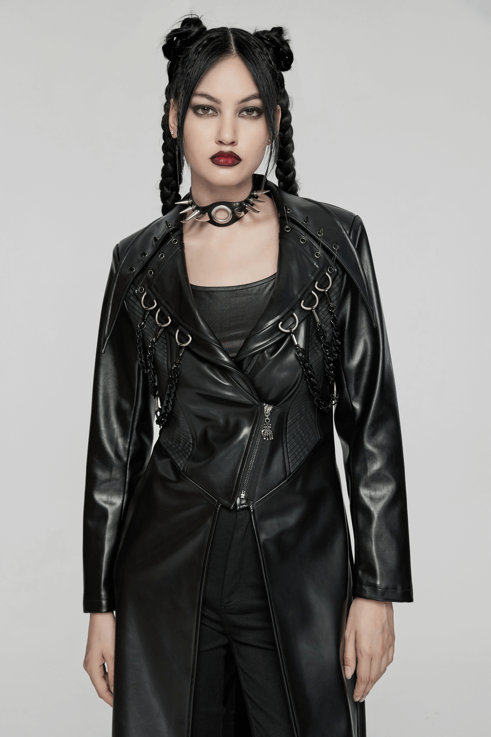 Model wearing an edgy PU leather long coat with chains and buckles, showcasing a bold punk aesthetic.