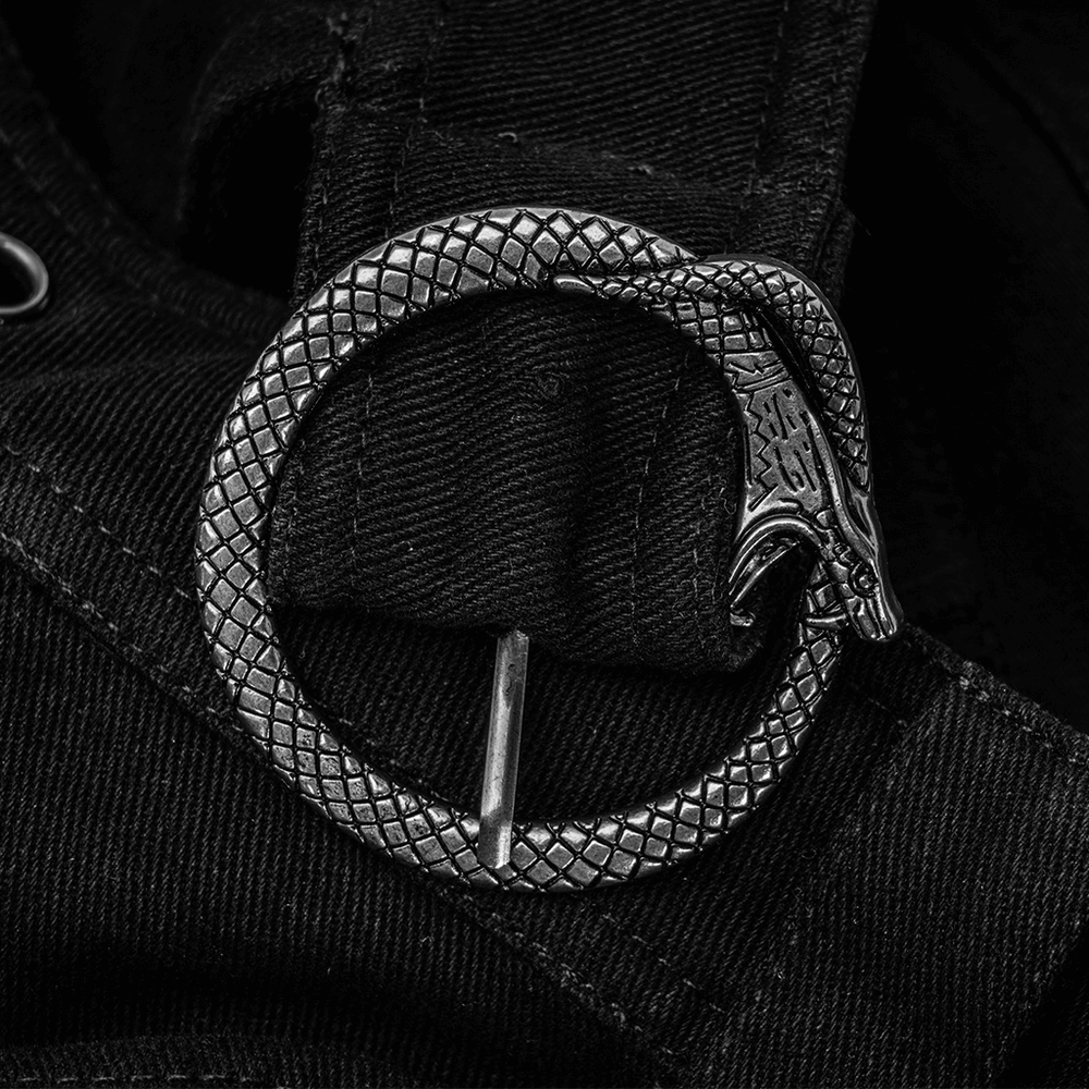 Close-up of a snake buckle on black fabric, adding an edgy touch to punk fashion.
