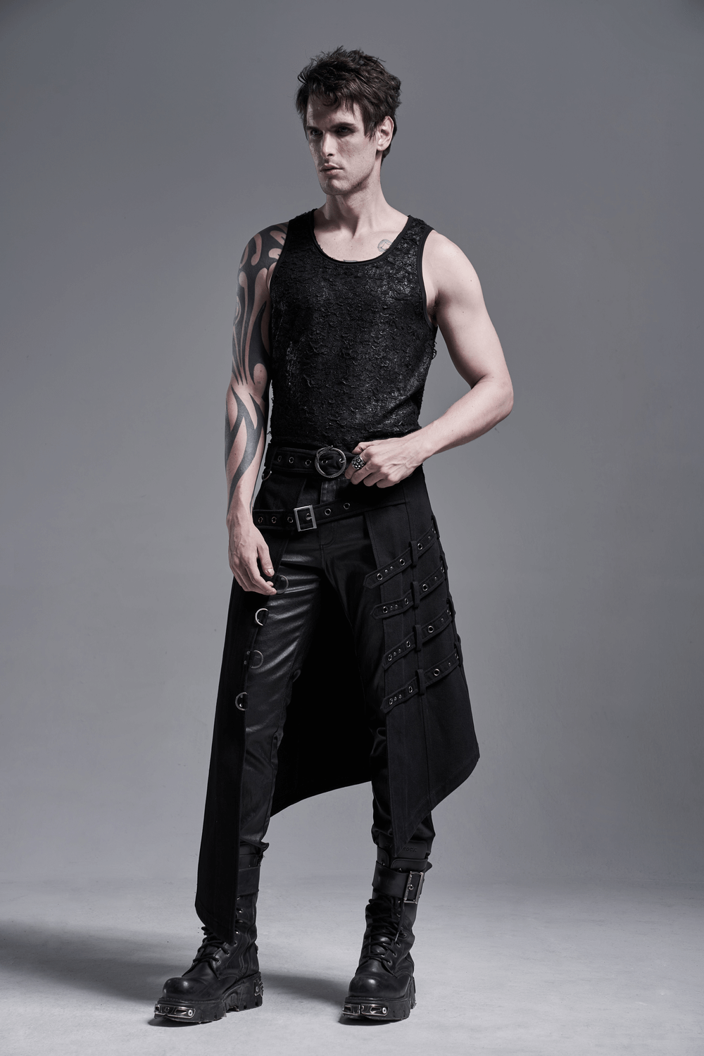 Model wearing edgy punk asymmetrical overskirt with snake buckle and black tank top, showcasing a bold fashion statement.