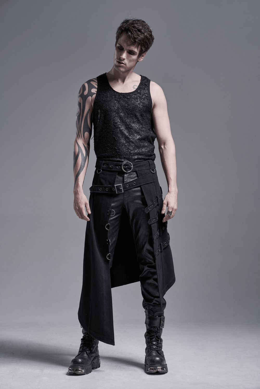 Model wearing an edgy punk asymmetric overskirt with snake buckle, stylish black outfit, and bold details.