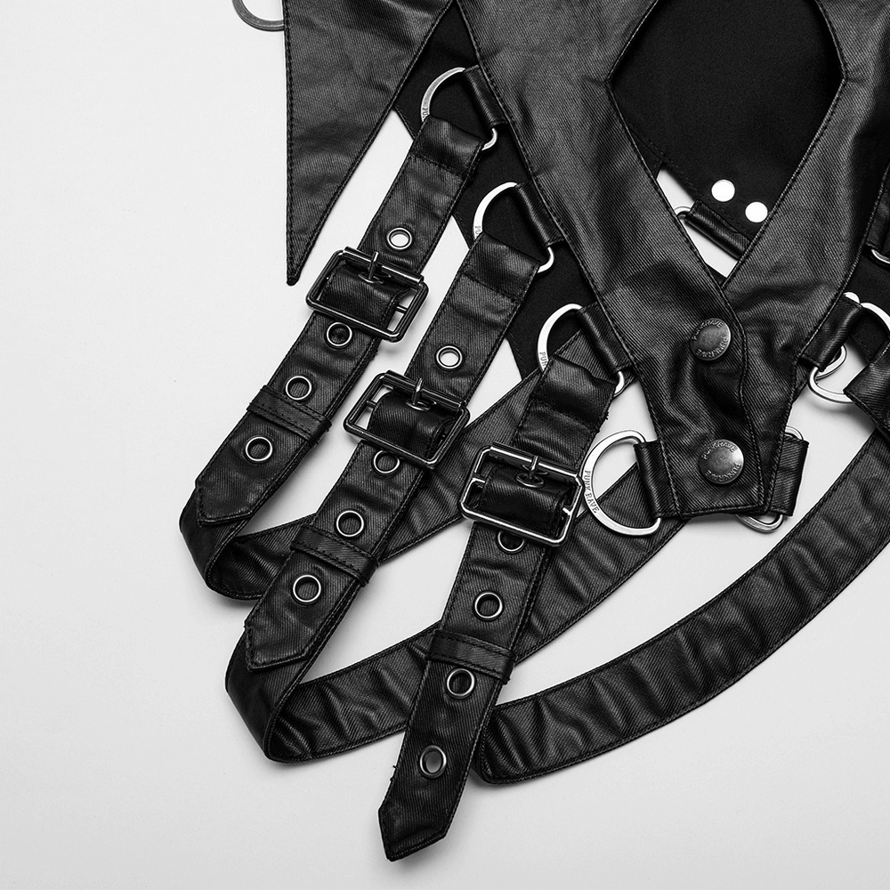 Edgy black punk cape detailing with adjustable buckles and straps for a unique avant-garde style.