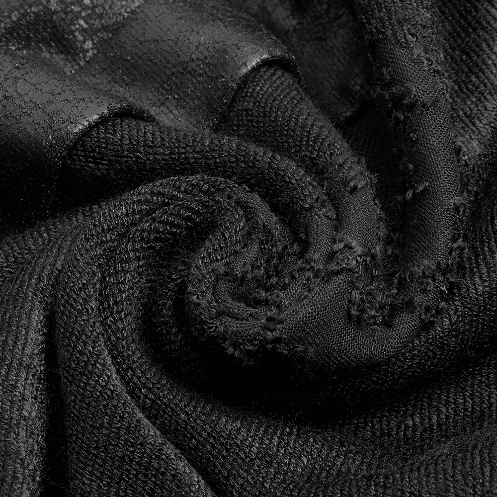 Close-up of unique black textured fabric with crackle design for edgy punk long coat.