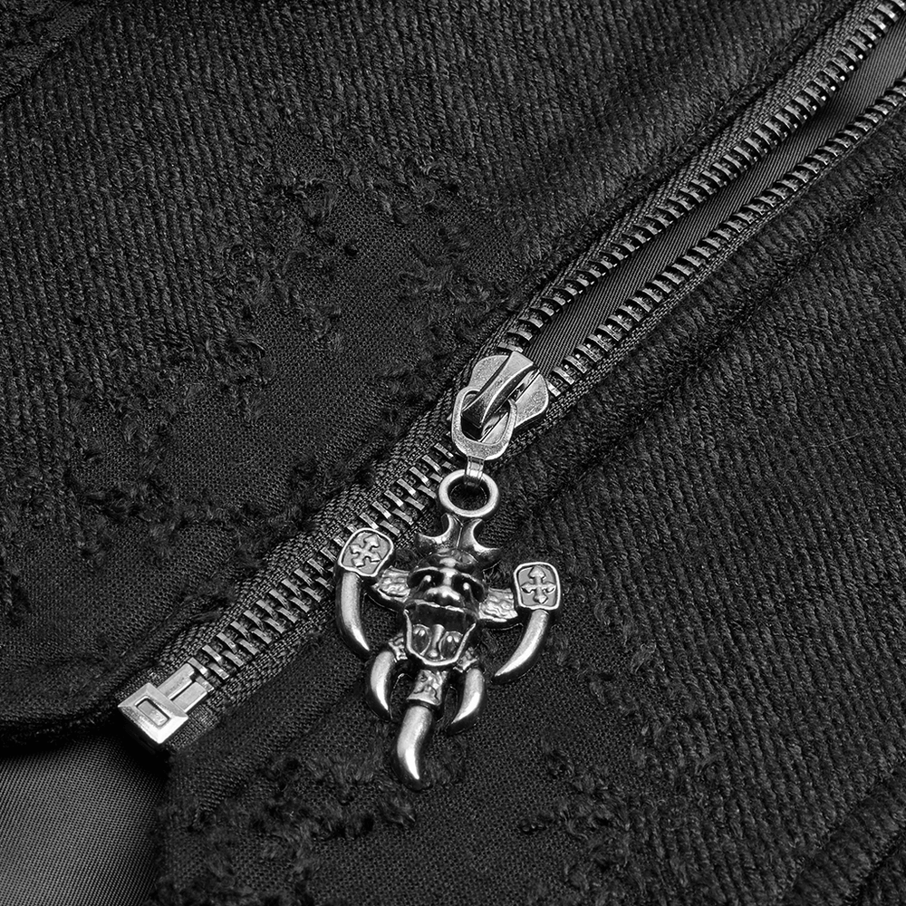 Close-up of a black zipper with a punk skull charm, detailing the edgy design of the long coat.