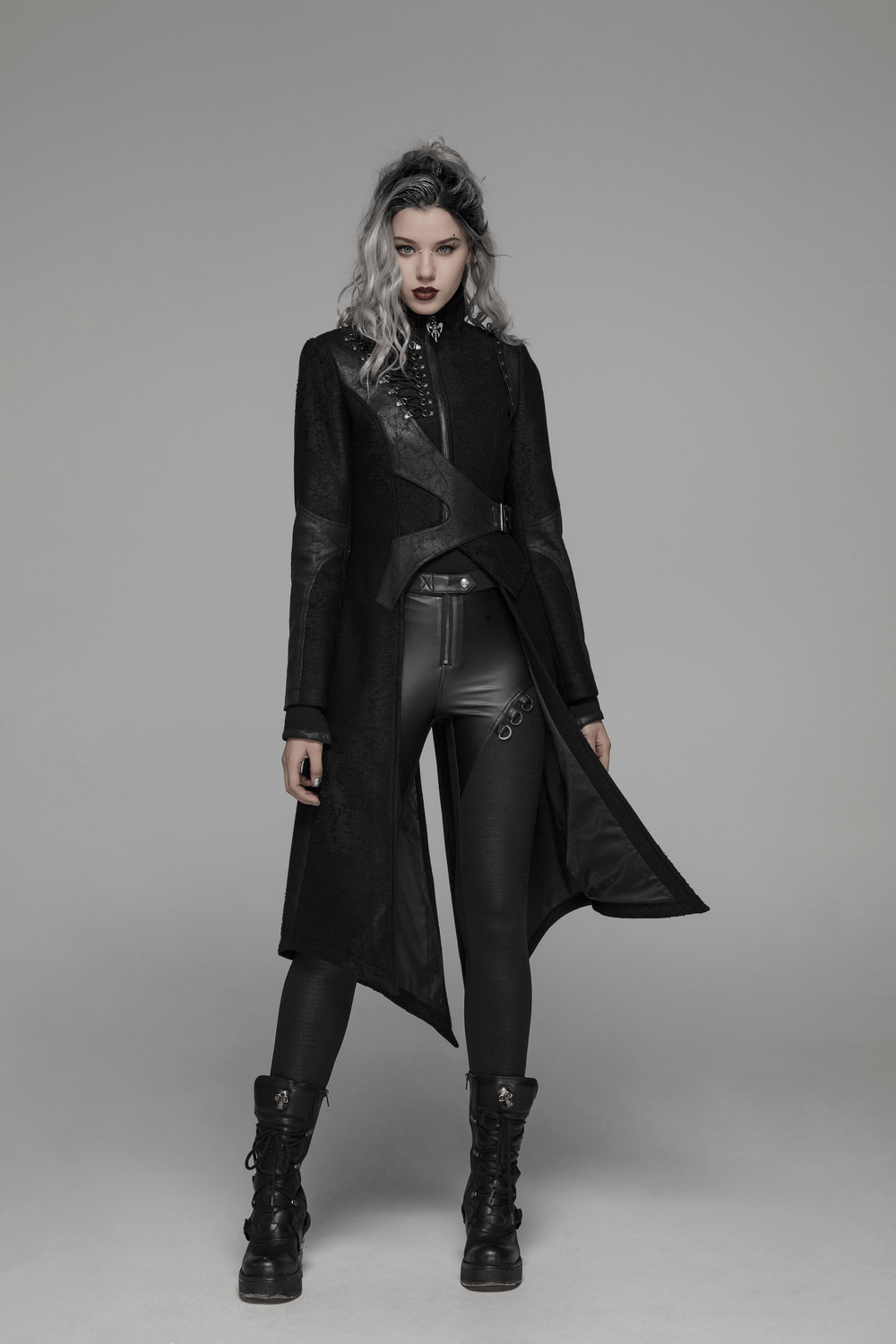 Edgy punk long coat with asymmetric design, adjustable waist, and sharp-angled hems, worn on a model.