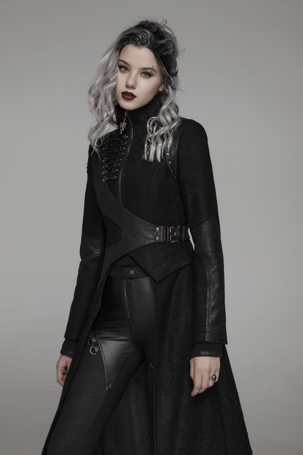 Edgy punk lace-up long coat with asymmetric design and adjustable waist, styled with sharp-angled hems and metal accents.