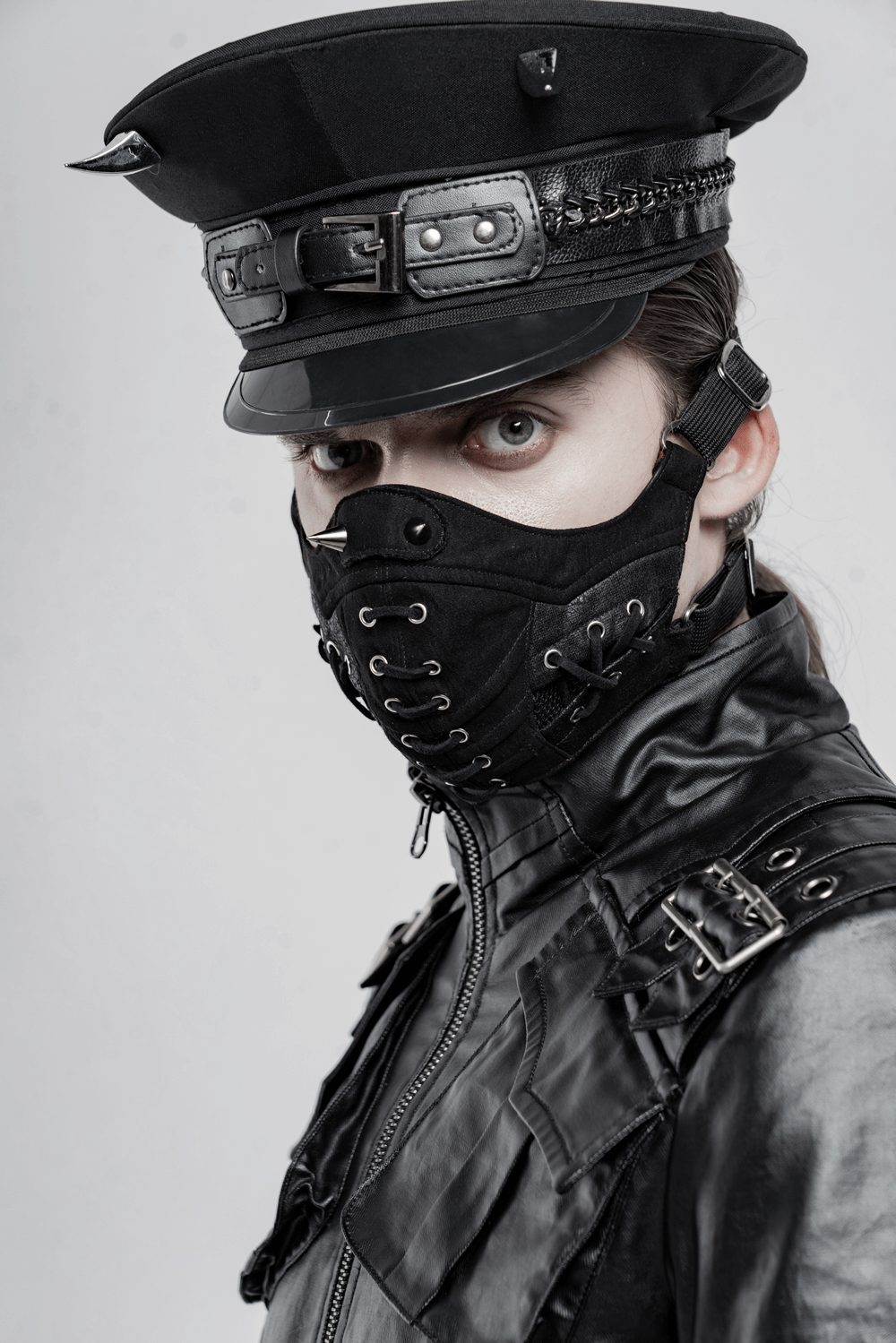 Edgy punk model wearing a stylish black mask and military-inspired hat, showcasing bold fashion aesthetics.