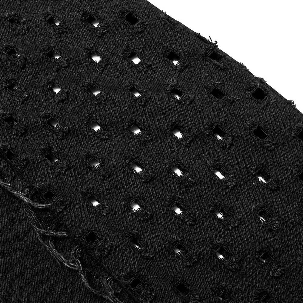 Close-up of distressed black fabric with frayed edges and intentional holes, showcasing punk style details.
