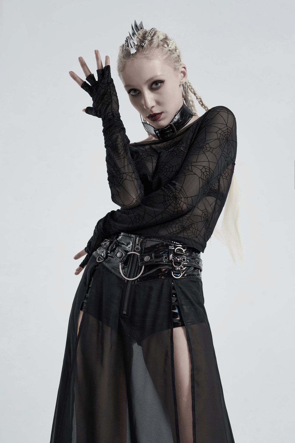 Model wearing an edgy punk spider mesh top with half-cut cuffs and a dramatic skirt, showcasing alternative fashion vibes.