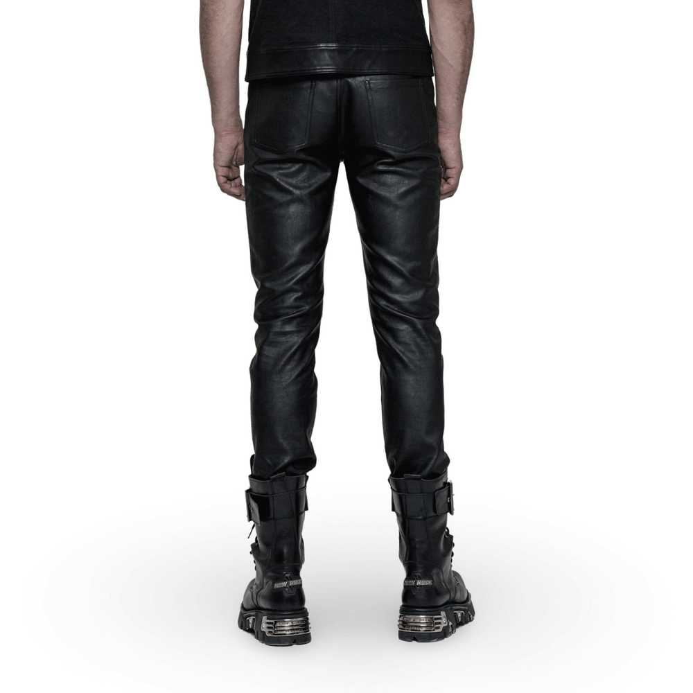 Stylish man showcasing edgy punk PU slim-fit trousers from the back, paired with trendy black boots.