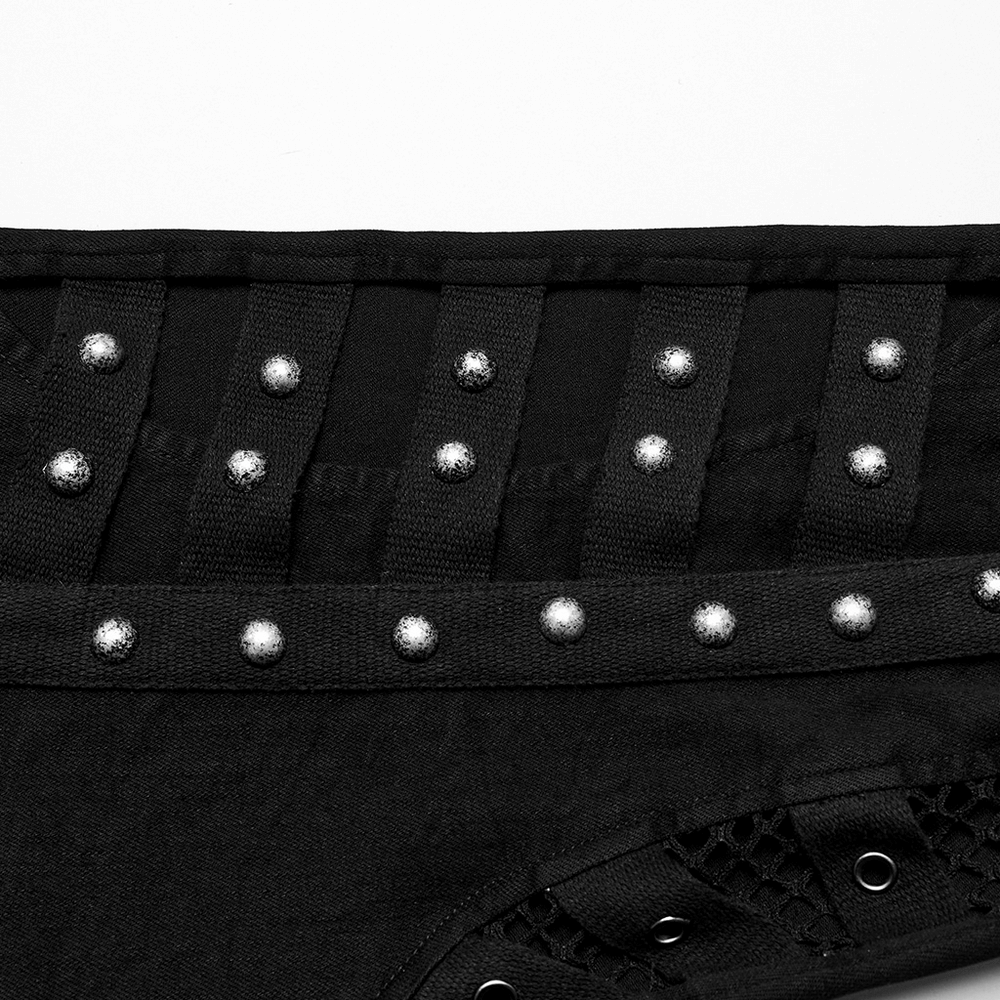 Close-up of edgy punk jeans showing riveted details and mesh paneling for a unique fashion statement.