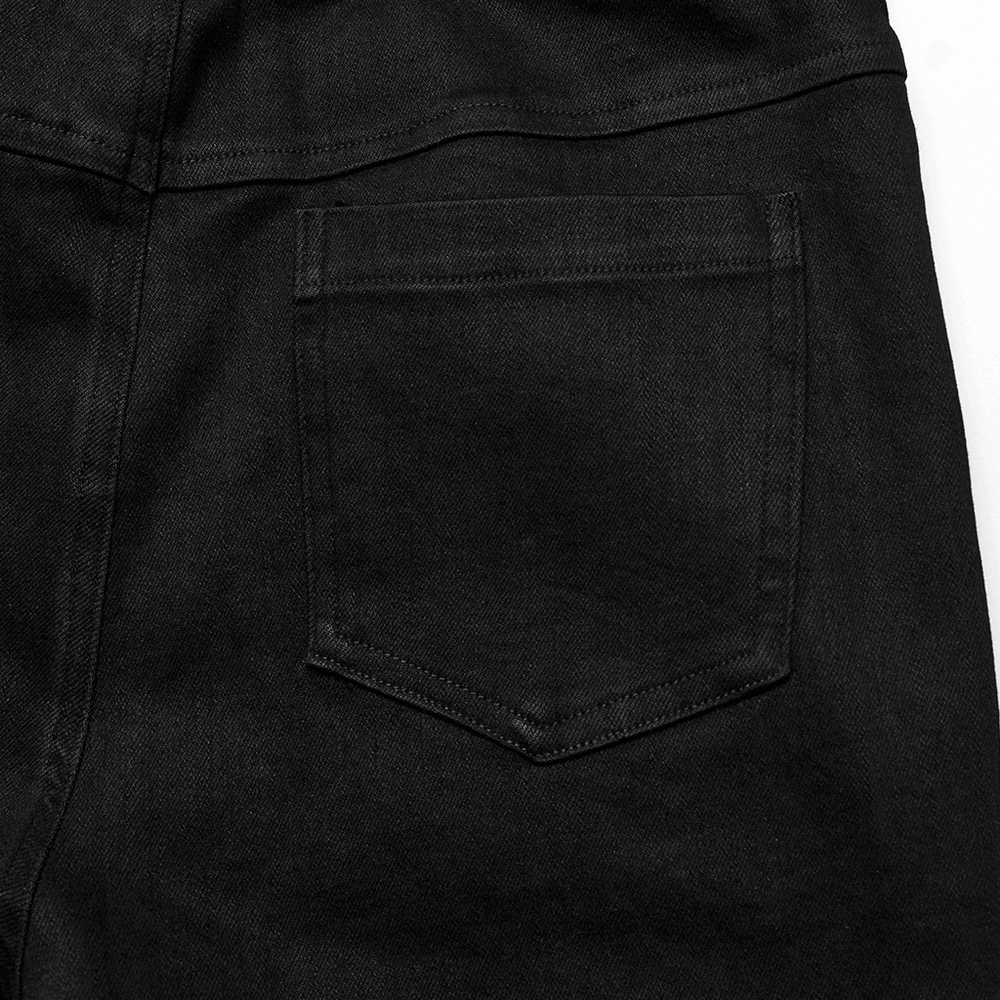 Close-up of the back pocket of black edgy punk slim jeans, showcasing stretch denim fabric and sleek design.