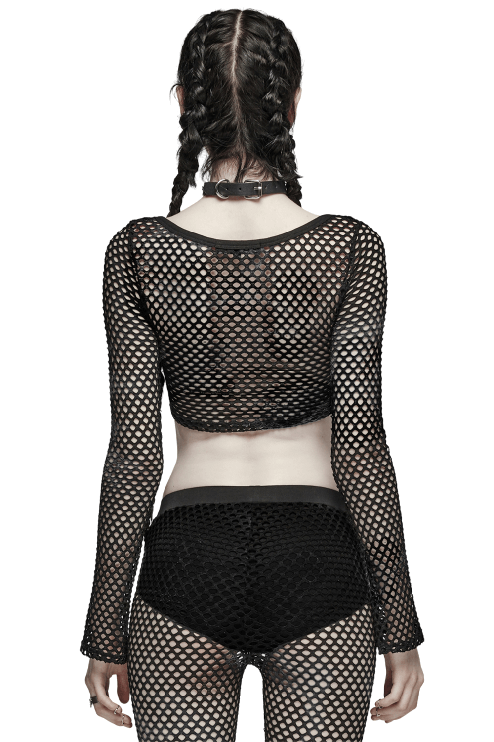 Woman in a black mesh long sleeve crop top showcasing a trendy fishnet design, accented with stylish shorts.